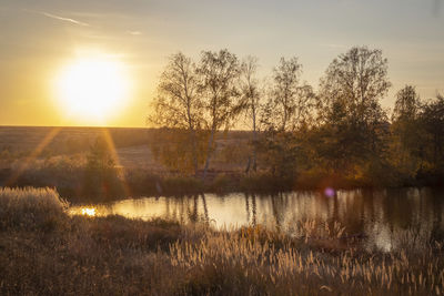 Scenic view of lake against sky during sunset