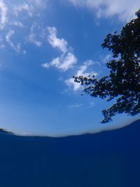 Low angle view of mountain against blue sky