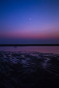 Scenic view of sea against clear sky at sunset