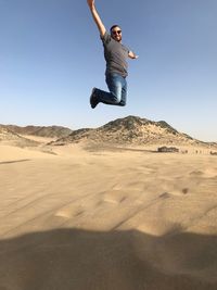 Man jumping in desert