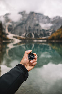 Cropped hand holding navigational compass