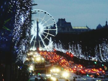 Low angle view of illuminated ferris wheel at night