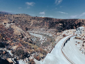 High angle view of road amidst mountains against sky