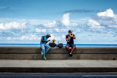 Young couple in sea against sky