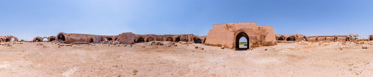 Panoramic view of historical building against clear blue sky