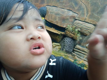 Close-up portrait of cute boy looking away