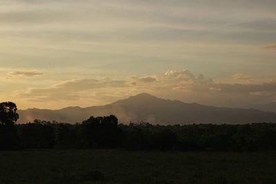 Scenic view of mountains against sky at sunset