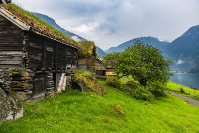 Building by mountain against sky