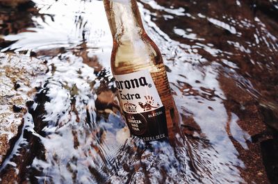 High angle view of text on glass bottle