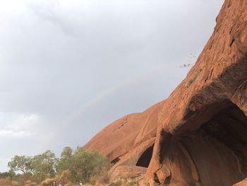 Scenic view of rainbow over mountain against sky