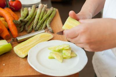 Midsection of man preparing food on cutting board