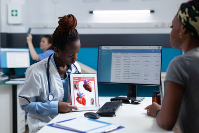 Doctor showing digital tablet to patient