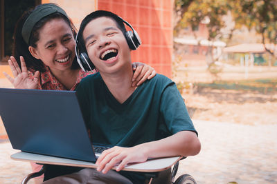 Special need child on wheelchair use a tablet in the house with his parent, study at home