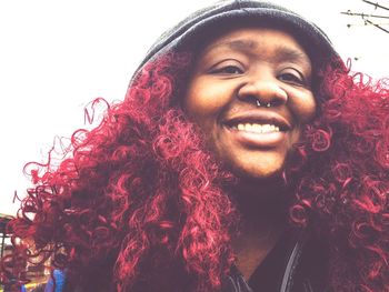 Close-up portrait of smiling redhead young woman