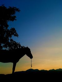 Silhouette of landscape against sky at sunset