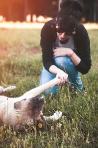 Woman with dog on field