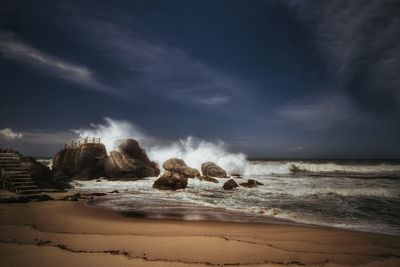 Scenic view of sea against cloudy sky