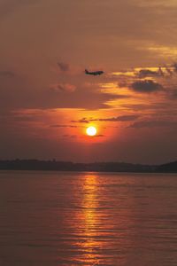 Scenic view of sea against orange sky