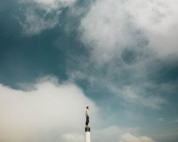 Low angle view of man standing against sky