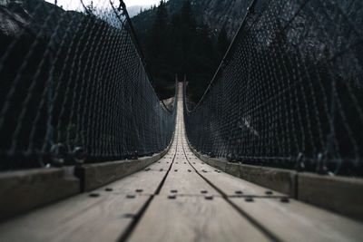 Surface level of footbridge against trees