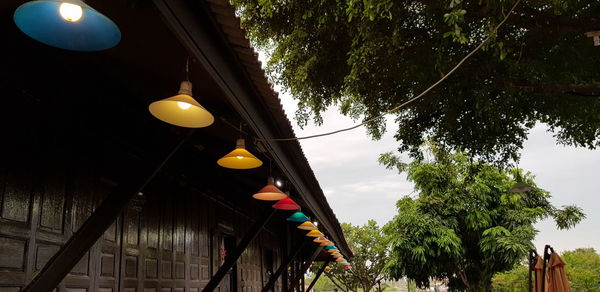 Low angle view of illuminated street light against sky
