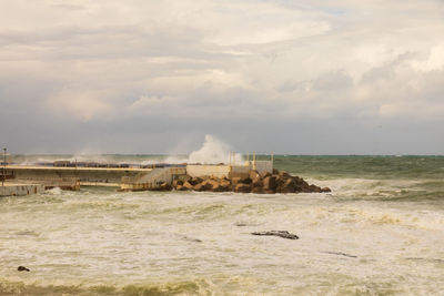 Scenic view of sea against cloudy sky