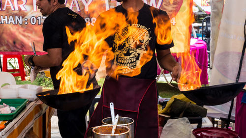 Midsection of man standing at market stall