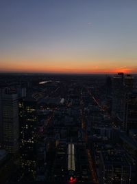 High angle view of illuminated buildings against sky at sunset