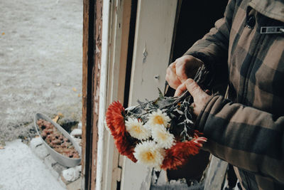 Portrait of young woman holding flower