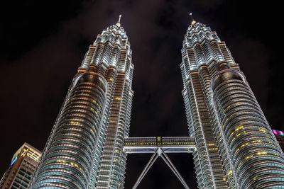 Low angle view of illuminated buildings against sky at night