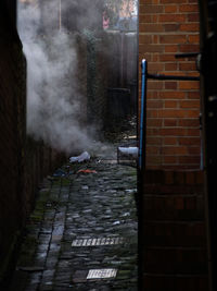 Footpath amidst buildings in city