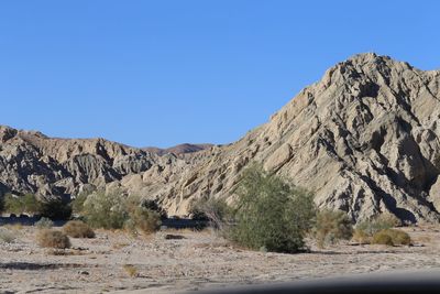 Scenic view of mountains against clear blue sky