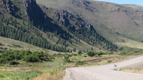 Scenic view of road by mountains