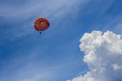 Low angle view of person against blue sky