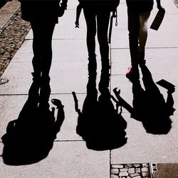 Low section of people standing on floor in city