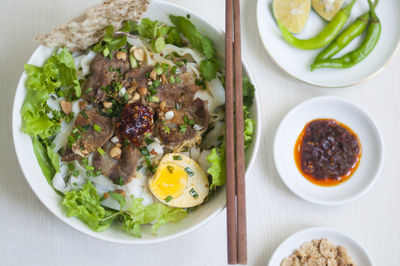 Vietnamese noodle - my quang, vietnamese traditional cuisine, noodles in bowl on the table 