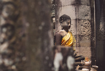 Statue against temple and building