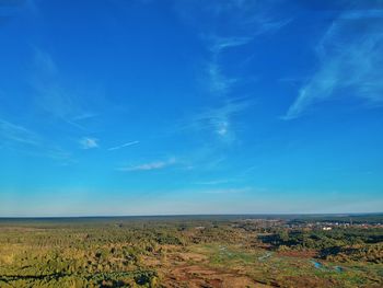 Scenic view of landscape against blue sky