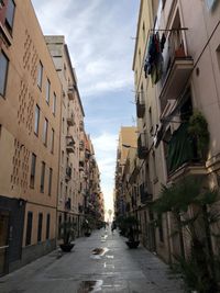 Street amidst buildings in city against sky