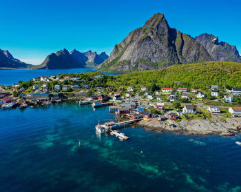 Aerial view of vivid coloured ocean, mountains and norwegian village in lofoten