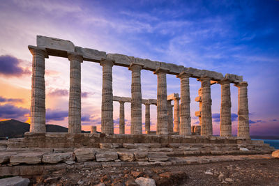 Temple of poseidon against sky during sunset