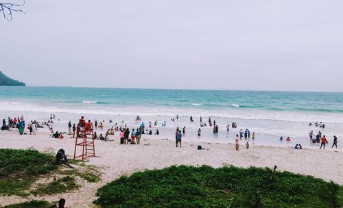 People on beach against sky