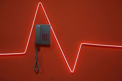 Low angle view of illuminated text on wall