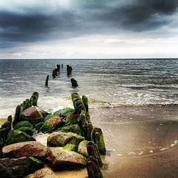 Scenic view of sea against cloudy sky