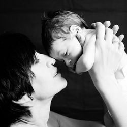 Close-up of mother lifting baby