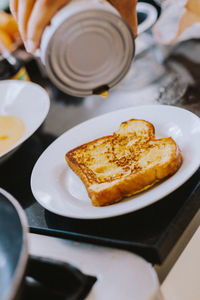 High angle view of maple syrup pour on french toasts 