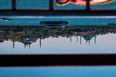 Reflection of building in lake against blue sky