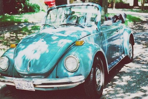 car, land vehicle, transportation, mode of transport, close-up, glass - material, focus on foreground, day, transparent, stationary, no people, street, outdoors, headlight, blue, reflection, still life, container, vintage car, cold temperature