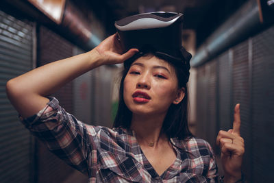 Portrait of young woman holding hat