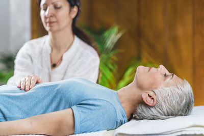 Woman giving massage to client at spa